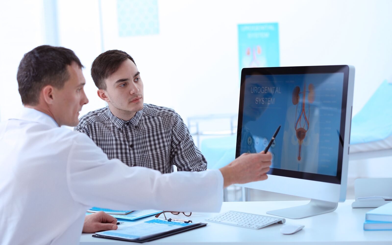 Medical concept. Doctor showing results of urology diagnostic on computer monitor